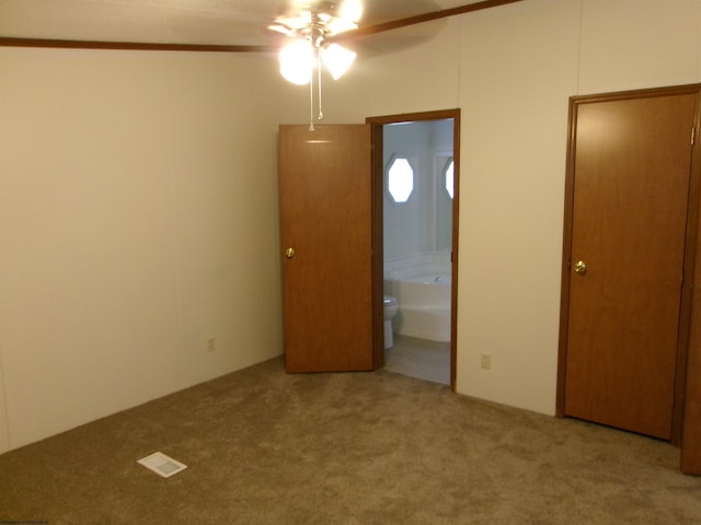 unfurnished bedroom with carpet flooring, ensuite bath, and visible vents