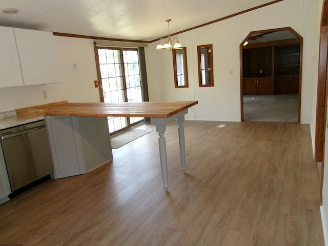 kitchen with dishwasher, crown molding, light wood-style floors, and arched walkways