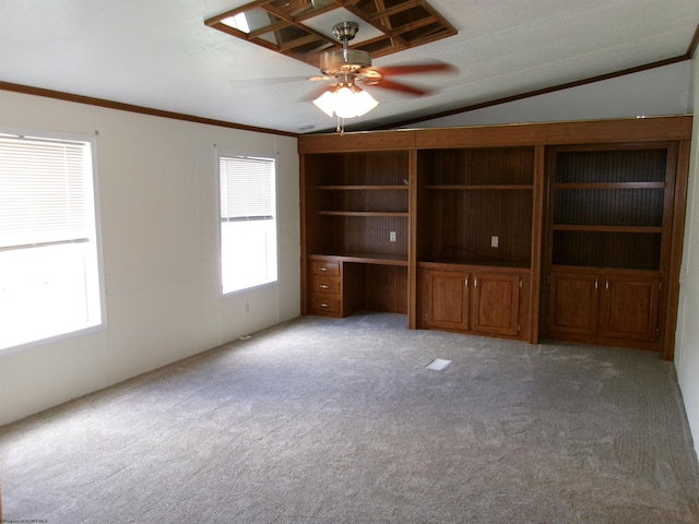 unfurnished living room featuring built in study area, ceiling fan, ornamental molding, vaulted ceiling, and light carpet