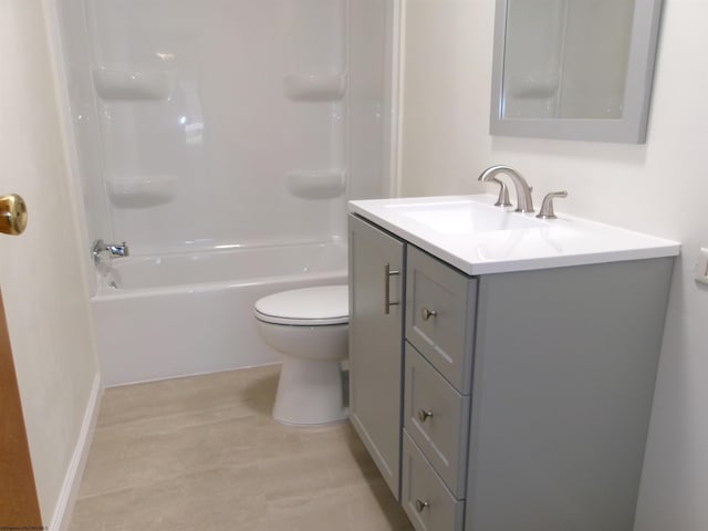 bathroom with vanity, shower / bathing tub combination, toilet, and baseboards