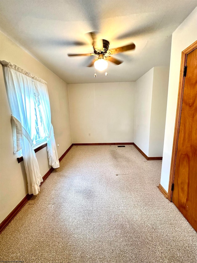 empty room with carpet and ceiling fan