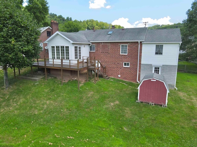 back of property with a wooden deck and a yard