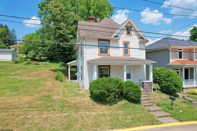 view of front of house with a garage and a front yard