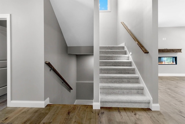 stairs featuring hardwood / wood-style flooring