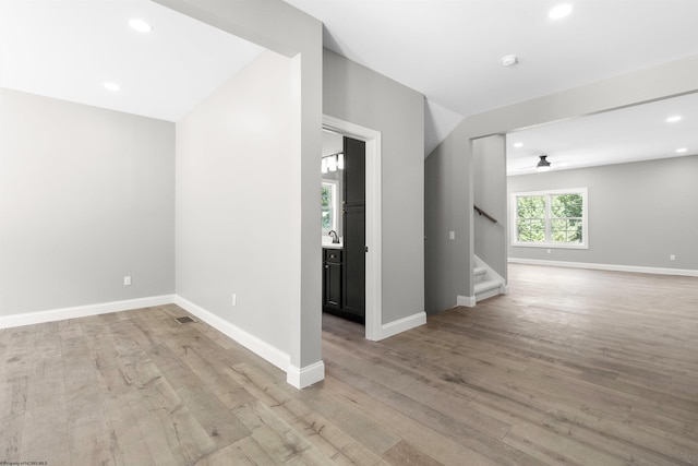 spare room featuring ceiling fan and light hardwood / wood-style flooring