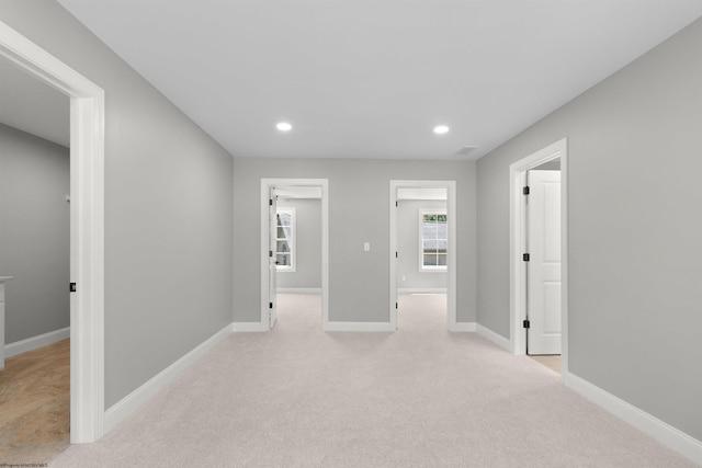 unfurnished room with light colored carpet