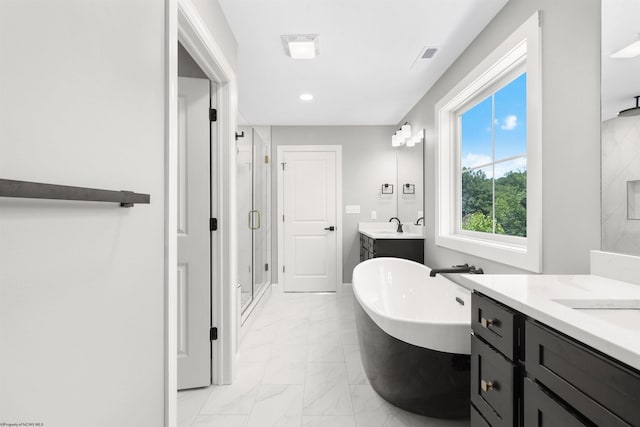 bathroom with separate shower and tub and vanity