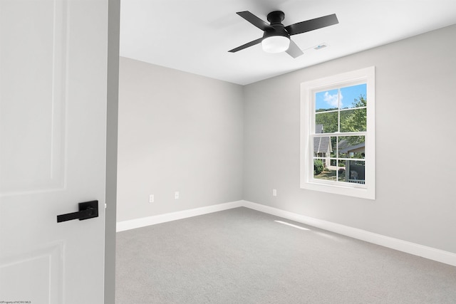 carpeted empty room featuring ceiling fan