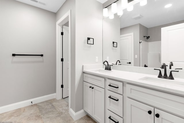 bathroom with vanity and a shower