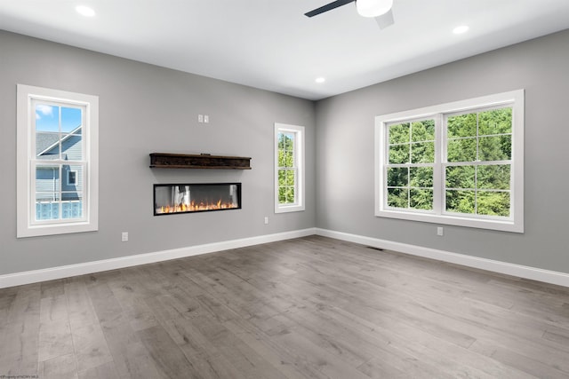 unfurnished living room featuring light hardwood / wood-style floors and ceiling fan