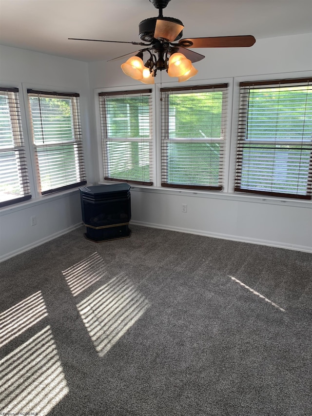 unfurnished sunroom with ceiling fan