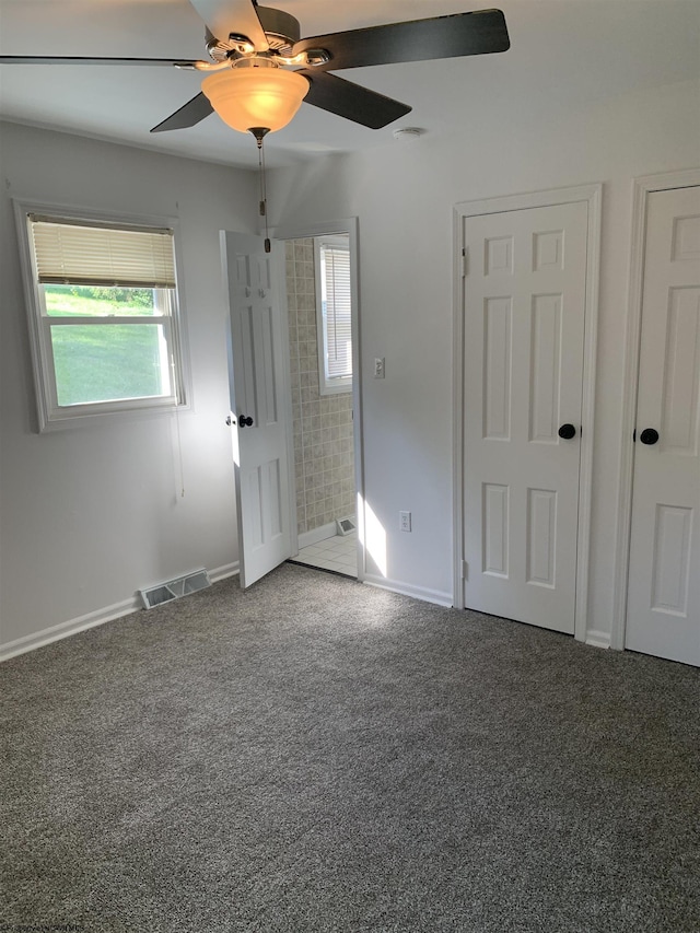 unfurnished bedroom with ceiling fan and carpet