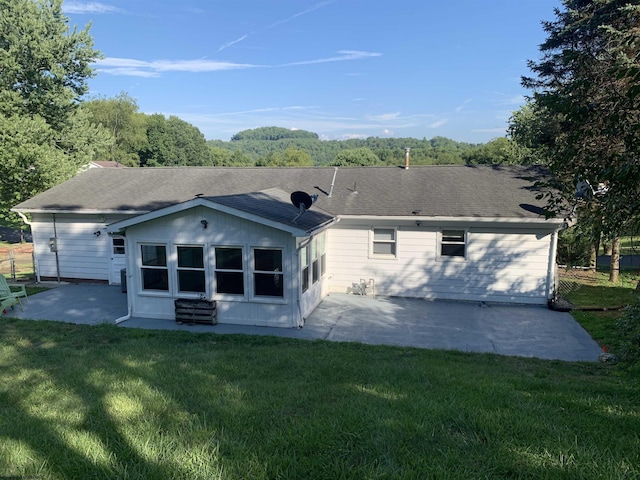 back of property featuring a patio and a lawn