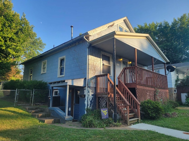 rear view of property featuring a lawn