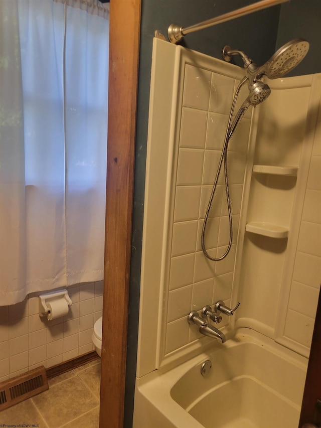 bathroom with tile patterned flooring,  shower combination, and toilet