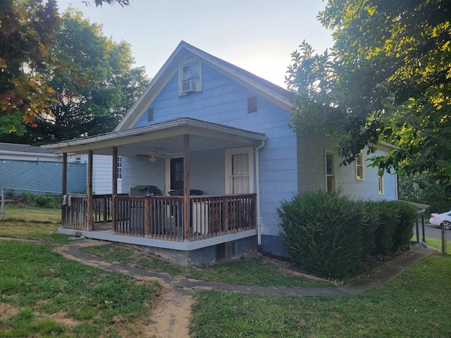 view of front of home with a front yard and covered porch