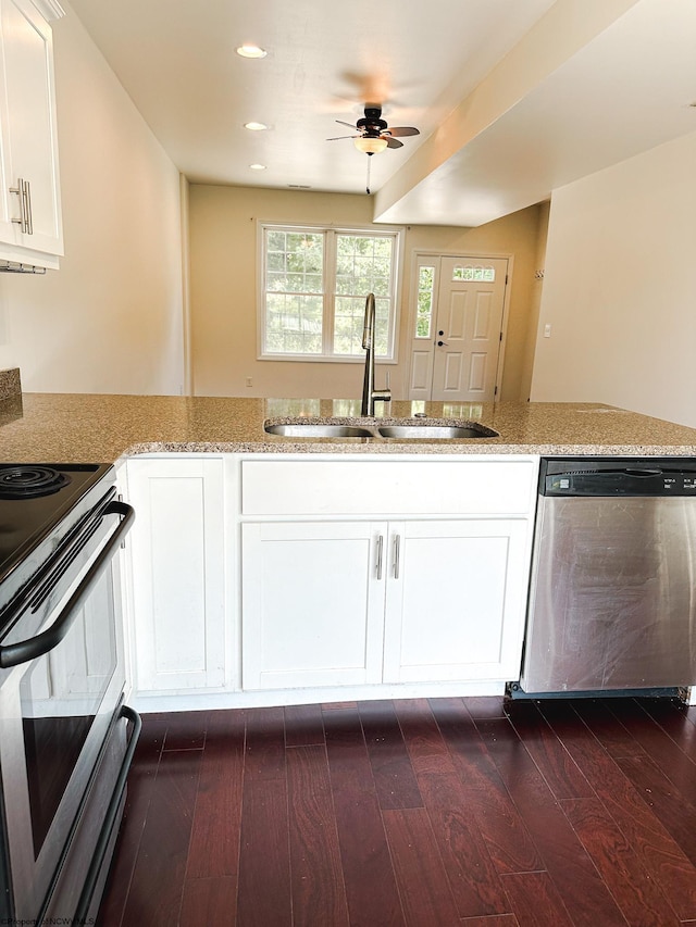 kitchen with sink, white cabinets, appliances with stainless steel finishes, and dark wood-type flooring