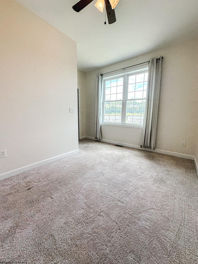 unfurnished room with carpet floors and ceiling fan