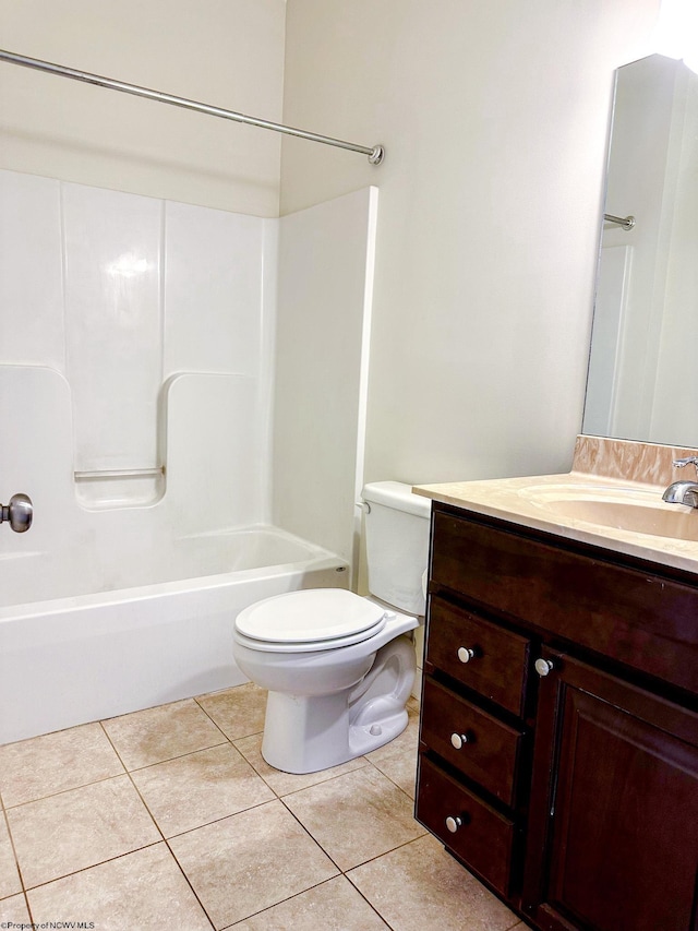 full bathroom featuring washtub / shower combination, toilet, vanity, and tile patterned flooring