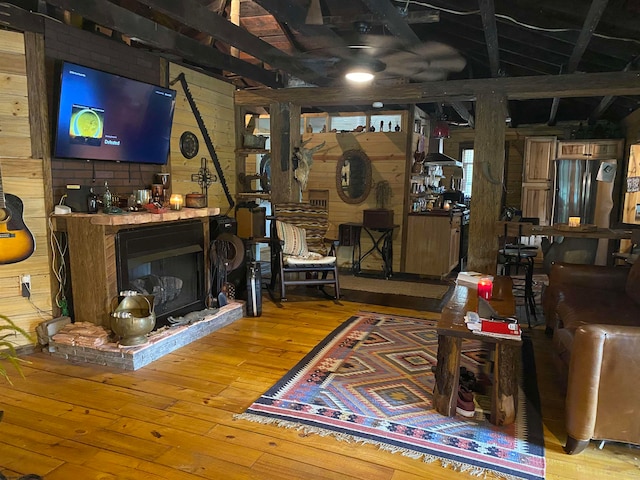 living room with wood walls and hardwood / wood-style floors