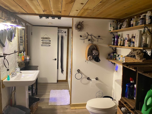 bathroom featuring wooden ceiling, wood-type flooring, and toilet