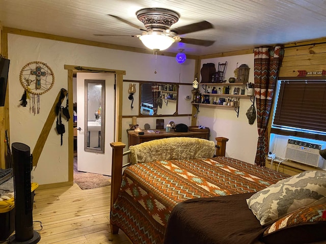 bedroom with cooling unit, ceiling fan, and light hardwood / wood-style floors