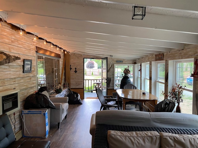 sunroom / solarium featuring lofted ceiling with beams