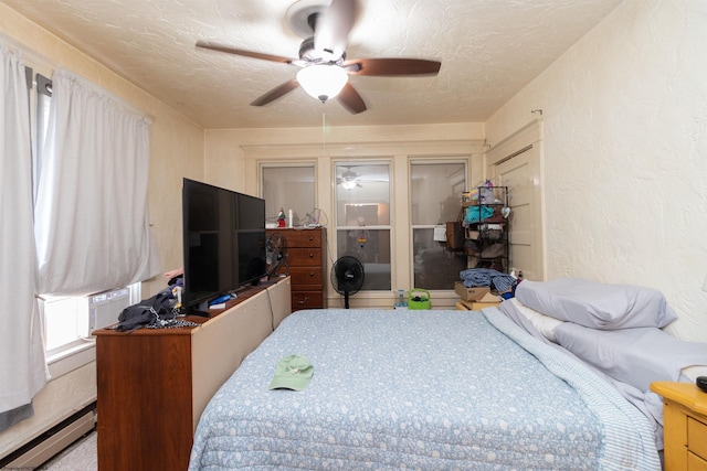 bedroom with cooling unit, ceiling fan, a baseboard radiator, and a textured ceiling