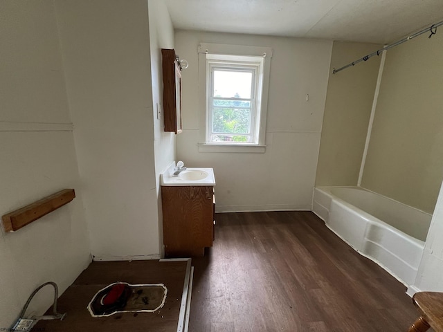 bathroom with tub / shower combination, vanity, and wood-type flooring