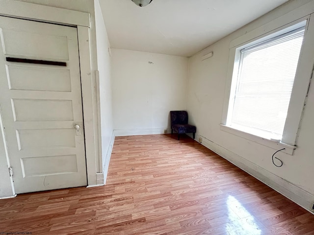 empty room featuring a wealth of natural light and hardwood / wood-style flooring