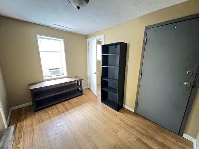 miscellaneous room featuring light wood-type flooring and a textured ceiling