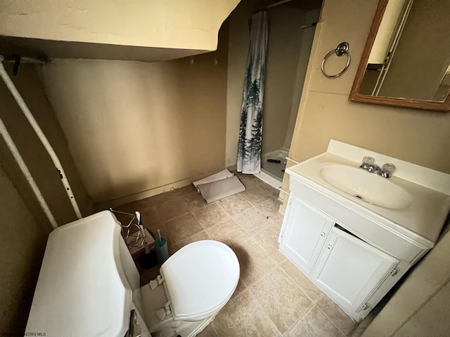 bathroom featuring vanity, tile patterned flooring, toilet, and a shower