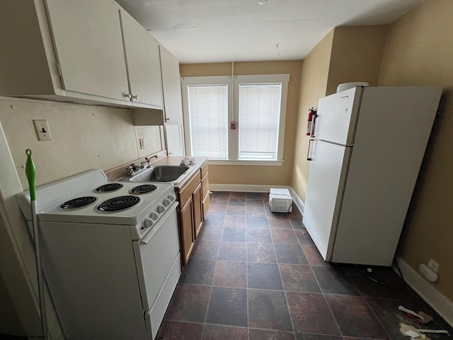 kitchen with sink, tile patterned flooring, white appliances, and white cabinetry