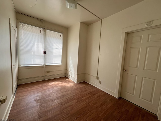 unfurnished bedroom with hardwood / wood-style flooring