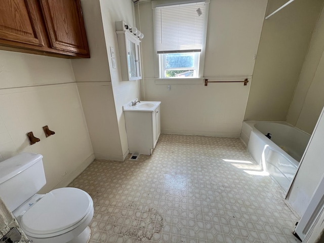 bathroom featuring vanity, tile patterned flooring, and toilet