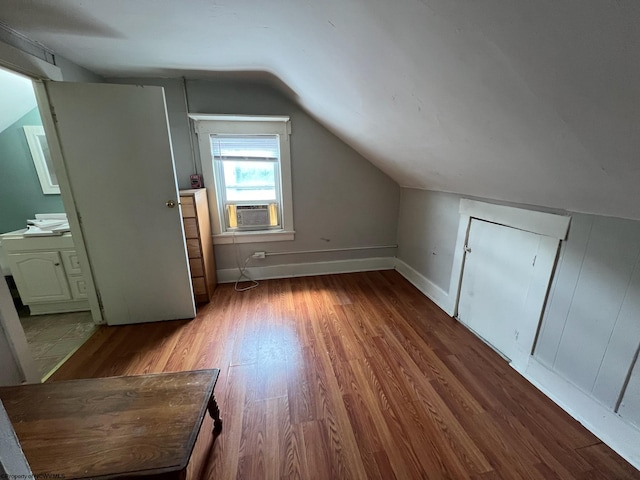 bonus room with lofted ceiling, hardwood / wood-style flooring, and cooling unit