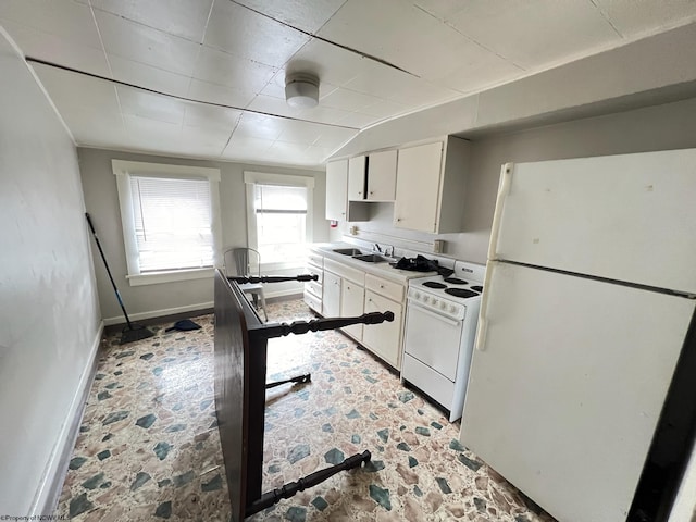 kitchen with sink, white cabinets, and white appliances