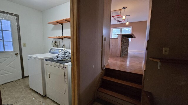 washroom with washer and dryer and light tile patterned floors