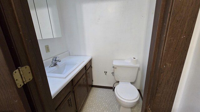 bathroom featuring vanity, tile patterned flooring, and toilet