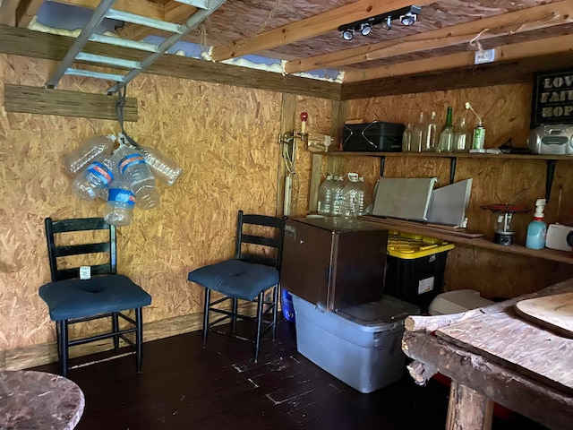 interior space featuring beamed ceiling and hardwood / wood-style floors