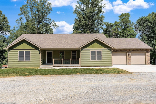 ranch-style home with a garage and covered porch