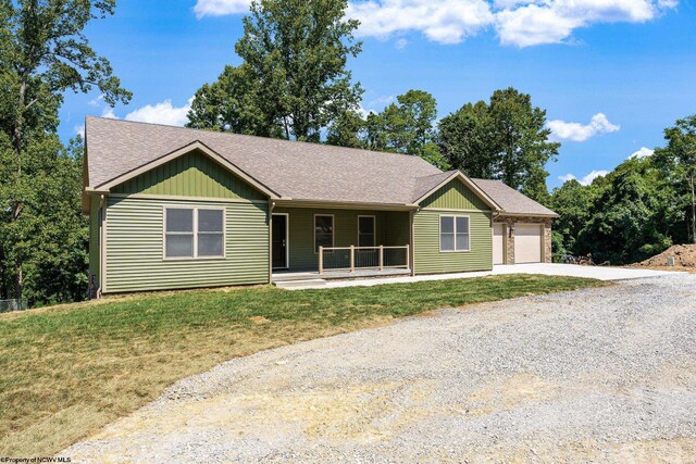 ranch-style house with a garage and a front lawn