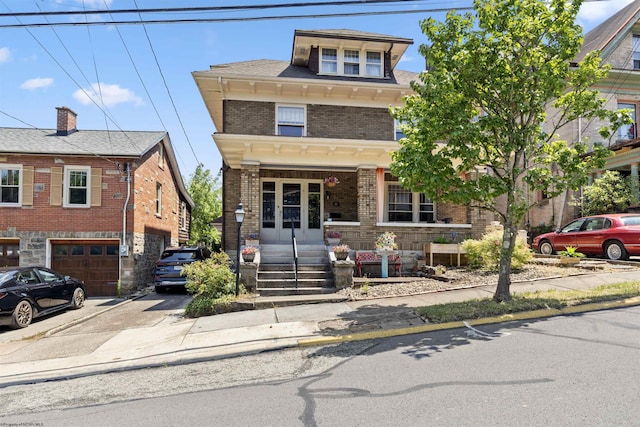 view of front of house with a garage and french doors