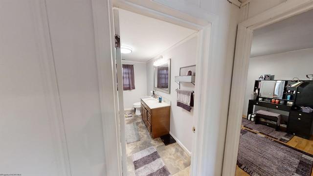 bathroom featuring tile patterned floors, toilet, vanity, and ornamental molding