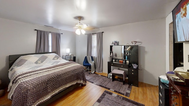 bedroom with light wood-type flooring and ceiling fan