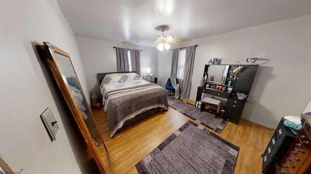 bedroom with ceiling fan and hardwood / wood-style floors