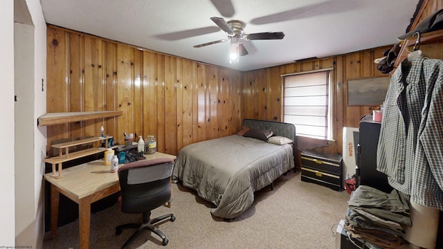 bedroom featuring wood walls, light carpet, and ceiling fan