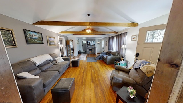 living room featuring light hardwood / wood-style floors and lofted ceiling with beams