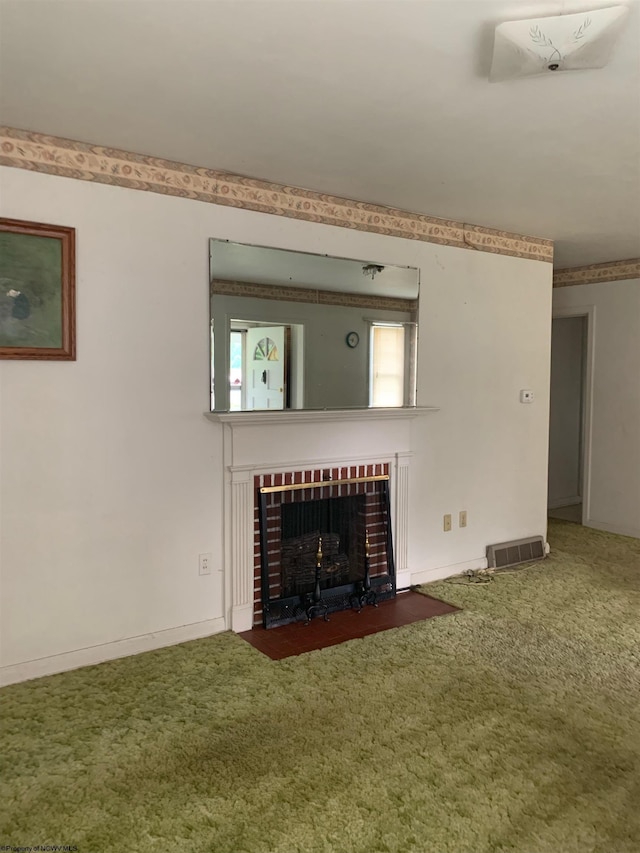 unfurnished living room with dark carpet and a fireplace