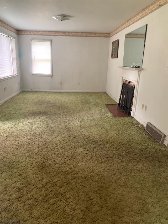 interior space featuring dark carpet and a fireplace